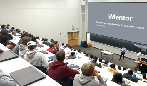 An iMentor presentation in a lecture hall.