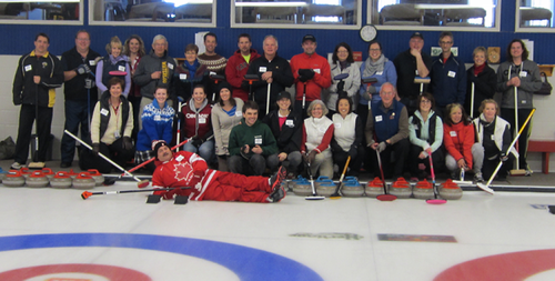 Participants in the Hagey Bonspiel pose for a group photo on the ice.