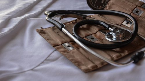 A doctor's stethoscope and a blood pressure cuff.