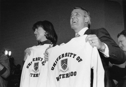 Prime Minister Brian Mulroney and his wife Mila hold up University of Waterloo sweatshirts during a visit to the campus in 1987.