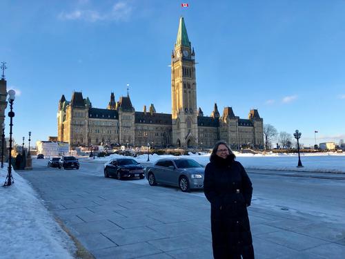 Professor Donna Strickland on Parliament Hill with the Parliament buildings behind her.