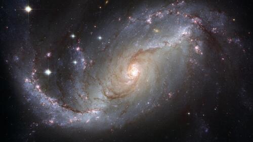 A photo of outer space including a galaxy.