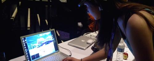 An XDM student uses a laptop as part of a digital installation.