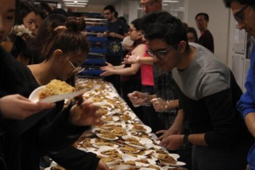 Students hand out free slices of pie in non-COVID times.