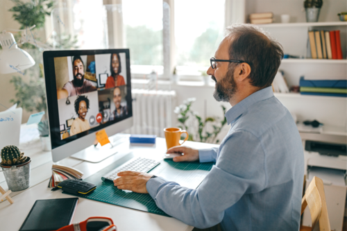 A man participates in a video call while sitting in his home office.