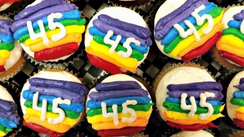 Cupcakes with rainbow icing and the number 45 on them.