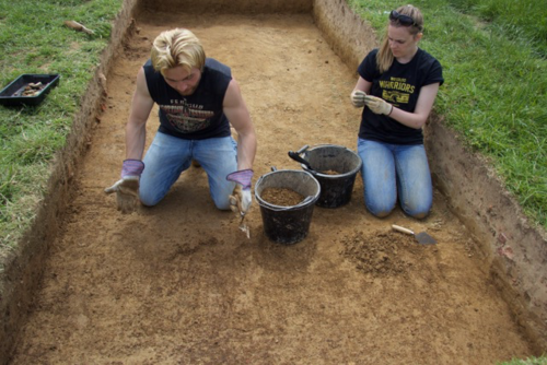 Waterloo students engage in archaeological activity at a dig site.