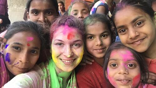 Waterloo alumnus Bridget King celebrates Holi with children during a co-op term in Chandigarh, India.