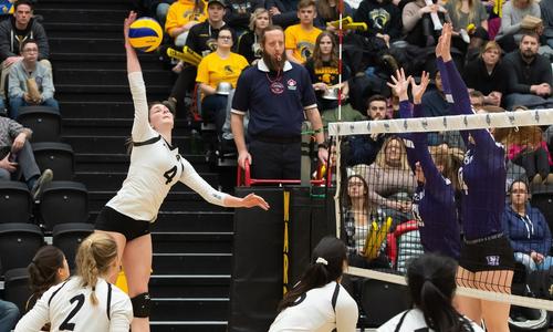 Sarah Glynn spikes a volleyball during a game against Western.