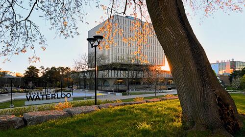 The Dana Porter Library and Waterloo sign at sunset.