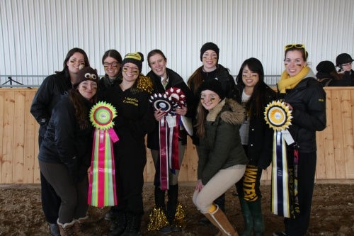 Members of the UW Equestrian Team pose with their winning trophies.