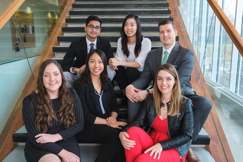 The six Co-op Students of the Year sit on the stairs in the Tatham Centre.