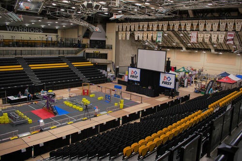 The FIRST Robotics competition setup on the floor of the Physical Activities Complex.