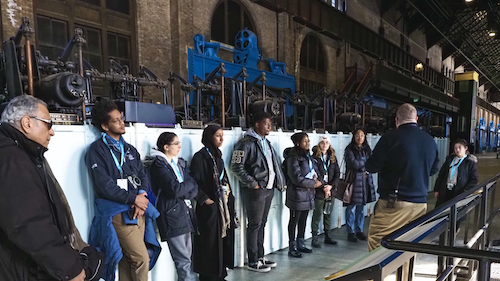 Students tour an Industrial Age-era factory floor.