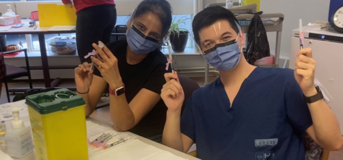 Alex Wong and another volunteer in PPE gear at an LTC facility.