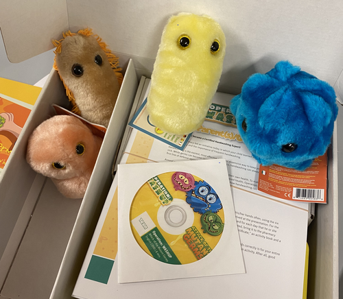 A kit including giant microbe plush toys and activity sheets designed by Waterloo Pharmacy students.