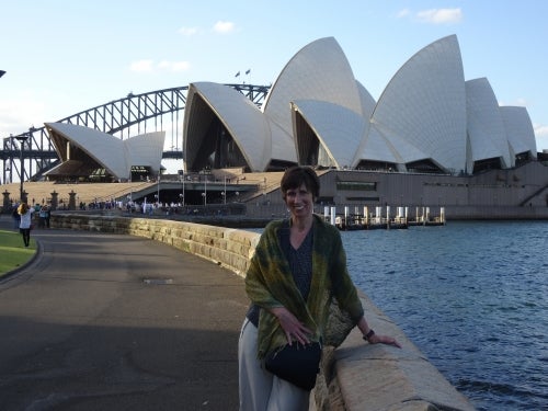 Susan Grant stands in front of the Sydney Opera House.