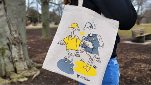 A person carries a tote bag that shows the winning goose design.