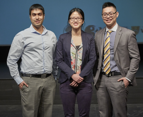 The three winners of the Three Minute Thesis competition stand on stage together.