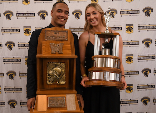 Tre Ford and Claire Mackenzie with their athletic trophies.