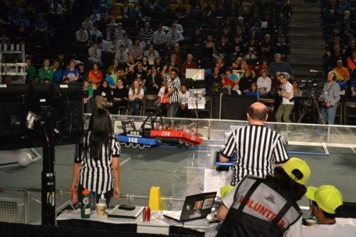 Two robots square off in the PAC at the FIRST Robotic competition.