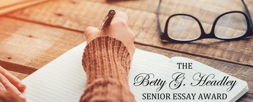 Betty G. Headley Essay Award banner image - a person writes in a journal.