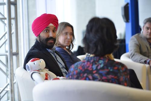 Minister Navdeep Bains speaks to Dean of Engineering Pearl Sullivan as a Faculty of Engineering robot reacts.