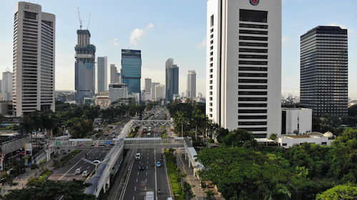 An urban environment in Indonesia with skyscrapers under constructions.