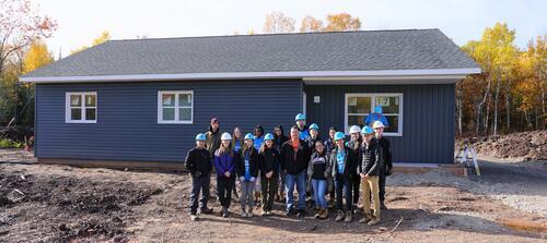 Members of Warrior Home pose with other stakeholders at the building site.