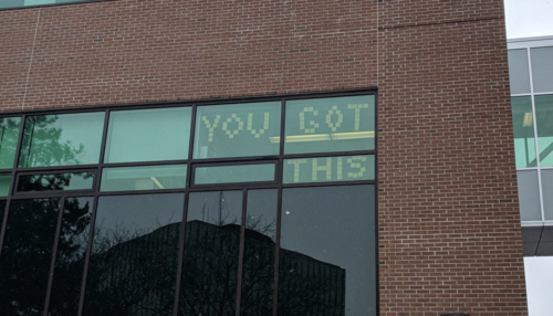 Sticky notes spell out &quot;YOU GOT THIS&quot; in an office window in the Needles Hall expansion.