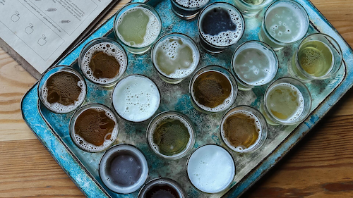 A tray full of beer glasses.
