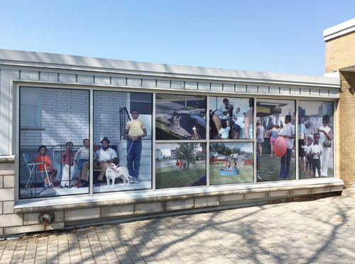 Enlarged photographs cover the windows of East Campus Hall as part of an art installation.