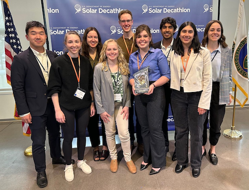 Members of Warrior Home (l-r) Richard He, Isabel Crant, Adriana Ceric, Anna van der Heide, Pierre Roy, Renee Champion, Asjad Khan, Talina Sen Smet and Rebecca Damsteegt pose with their award at the Solar Decathlon in Colorado.