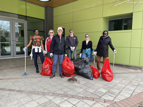 Campus clean-up volunteers with full trash bags.