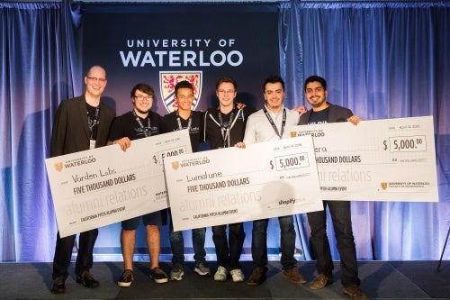 Winners of the pitch contest pose with their oversized cheques.