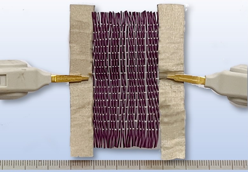 Two electrodes attached to a swatch of the new smart fabric.