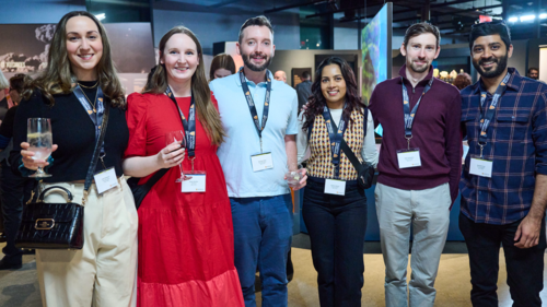 Attendees at the Alumni Chapter Launch event smile in a group photo.