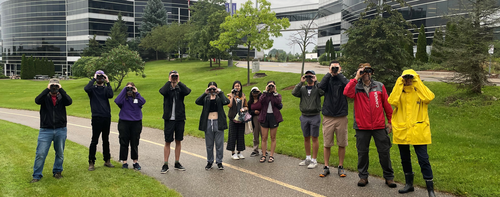 Bird watchers in the R+T Park peer through their binoculars.