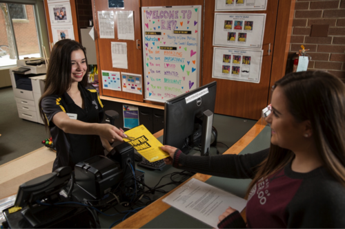 A student receives housing information from a Waterloo Residences representative.
