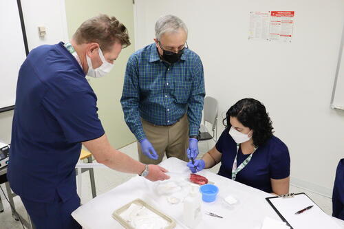 Instructor Dr. Richard Castillo (middle) offers instruction on radiosurgical techniques.