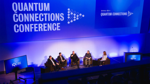 Panelists sit on stage conversing at the Quantum Connections conference.