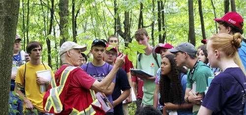A group of Envirothon participants in a forest.