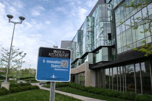 A &quot;Made in Kitchener&quot; walking tour sign affixed near the School of Pharmacy.