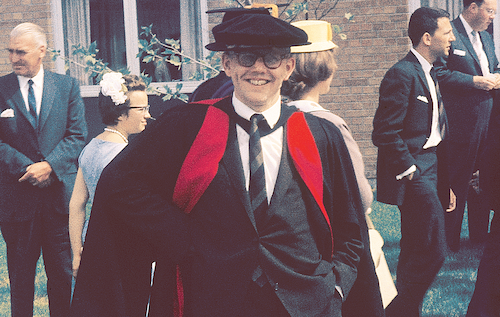 President Douglas Wright smiles while wearing university regalia at a Convocation ceremony in the 1980s.