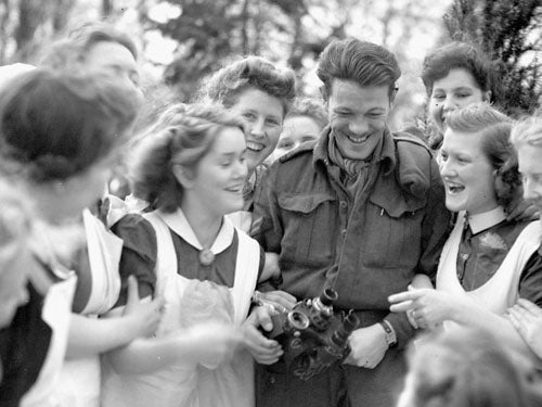 A Canadian soldier surrounded by Dutch women celebrating their liberation.