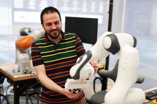 Gennaro Notomista interacts with a robotic arm