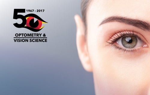 A close-up of a woman's eye with an Optometry 50th anniversary logo next to it.
