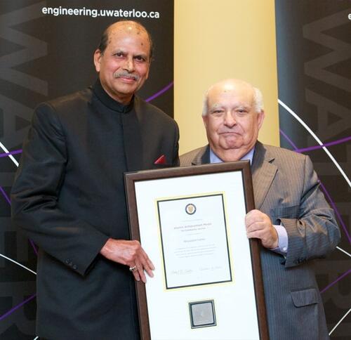 Nityanand Varma (left) receives a Waterloo Engineering award for community service from former dean Adel Sedra in 2011.
