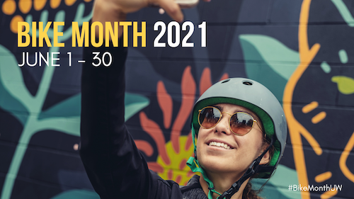 Bike Month banner - a person wearing a bicycle helmet takes a selfie.