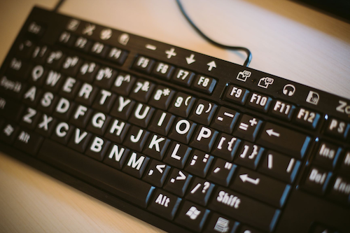 A close-up of an adaptive accessible computer keyboard.